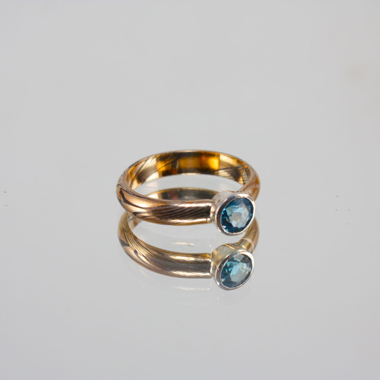 Gold-Mokume-Ring-with-Blue-Topaz