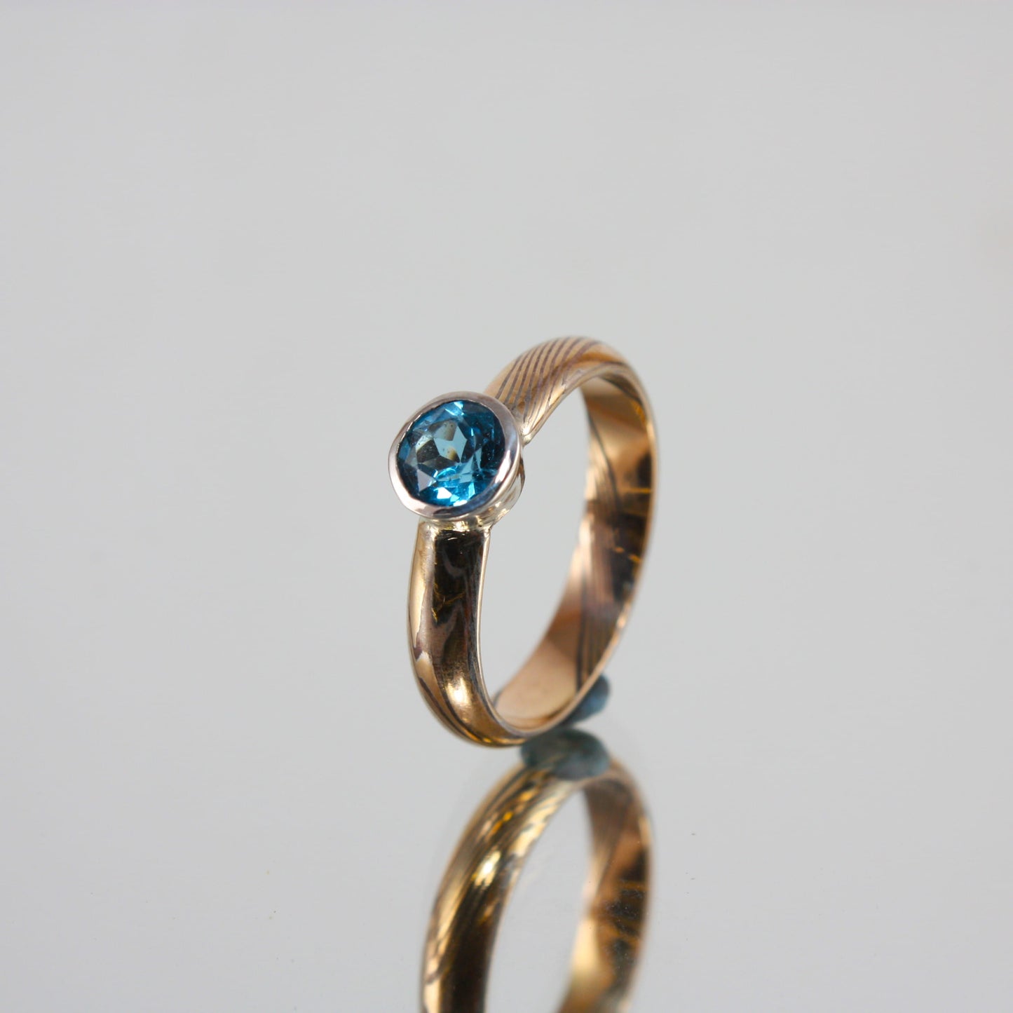 Gold-Mokume-Ring-with-Blue-Topaz