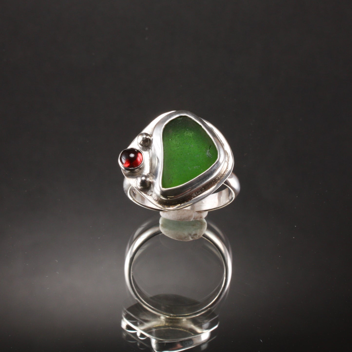 green sea glass ring with garnet.