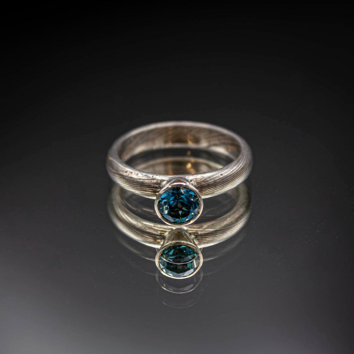 shibuichi mokume ring with blue topaz..
