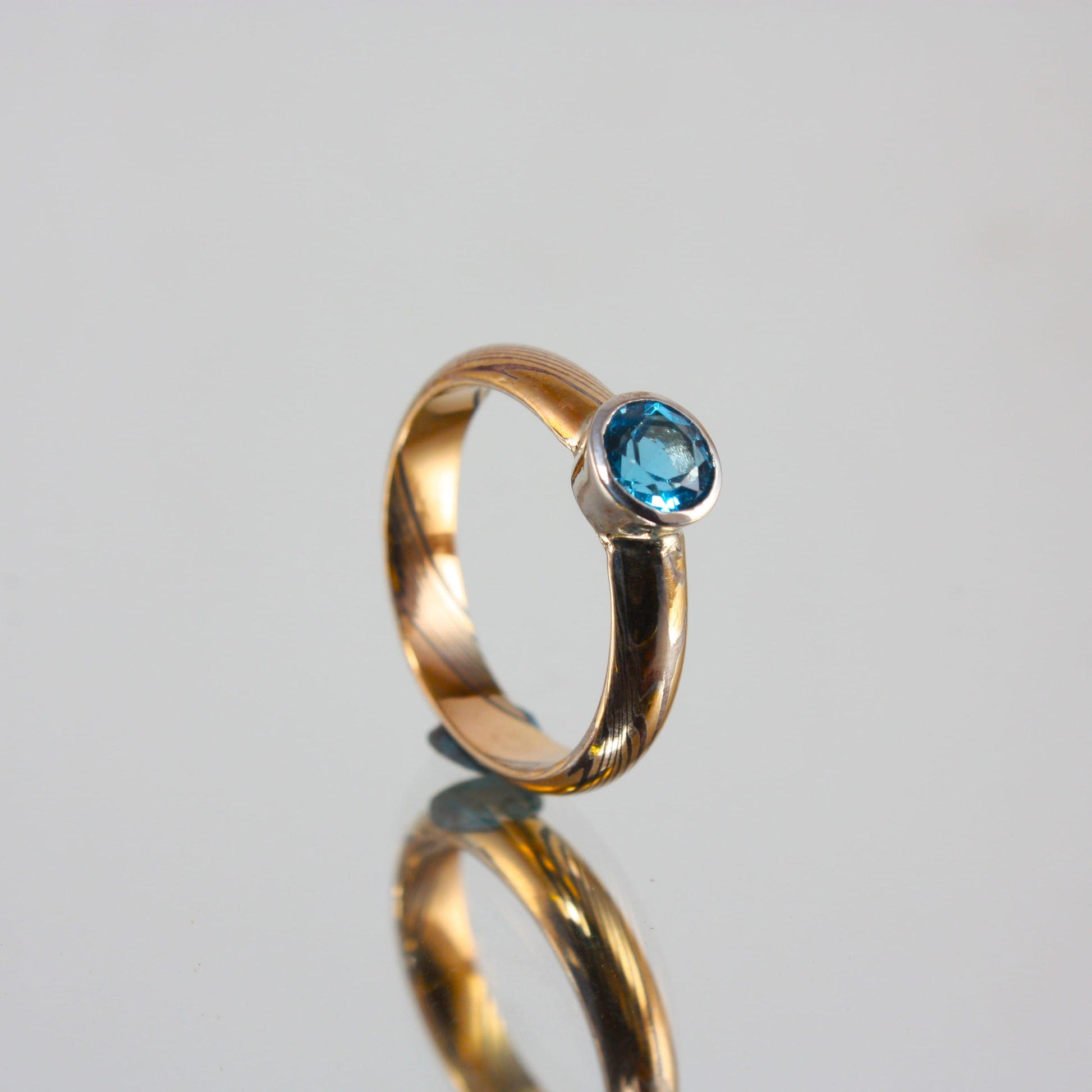 Gold-Mokume-Ring-with-Blue-Topaz