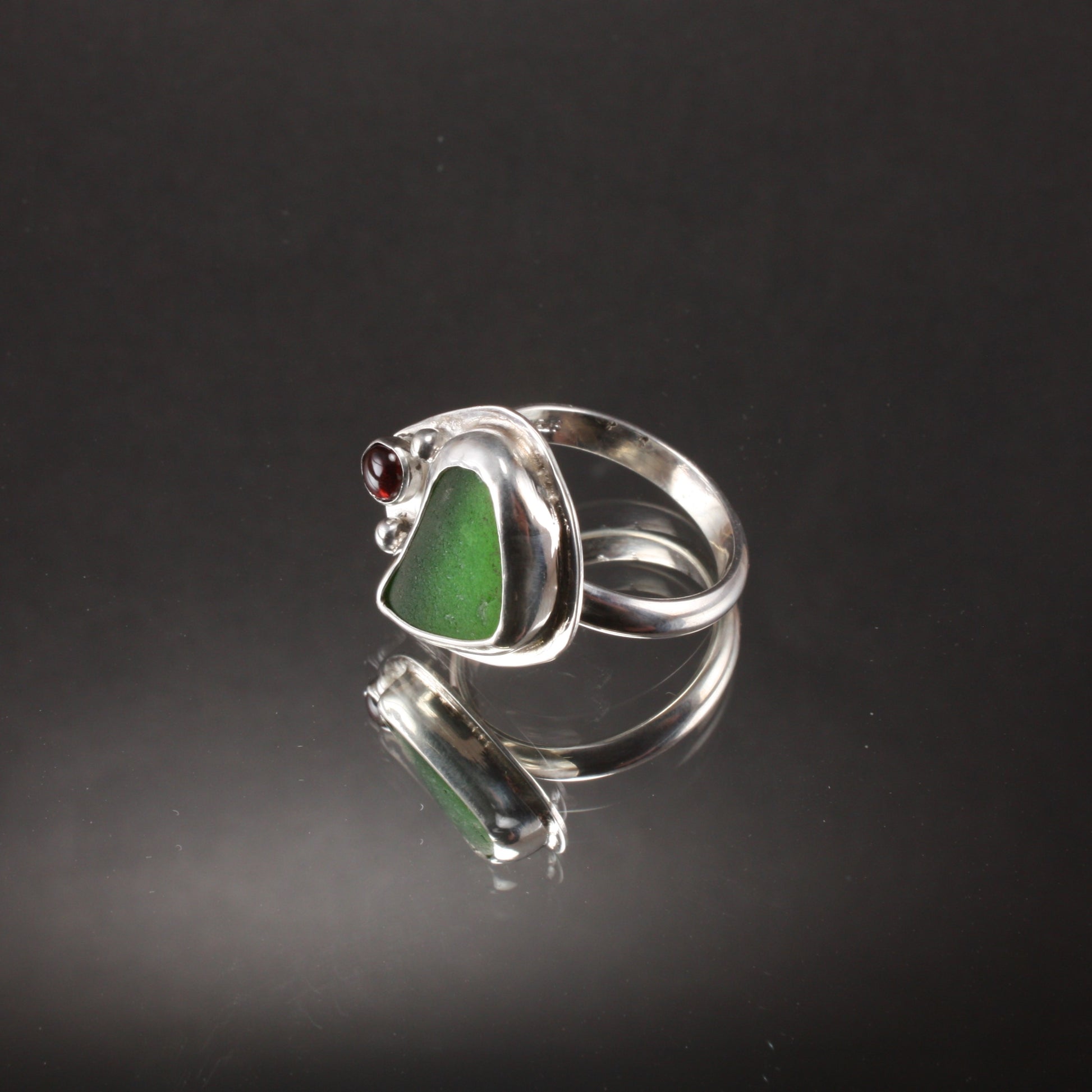 green sea glass ring with garnet..