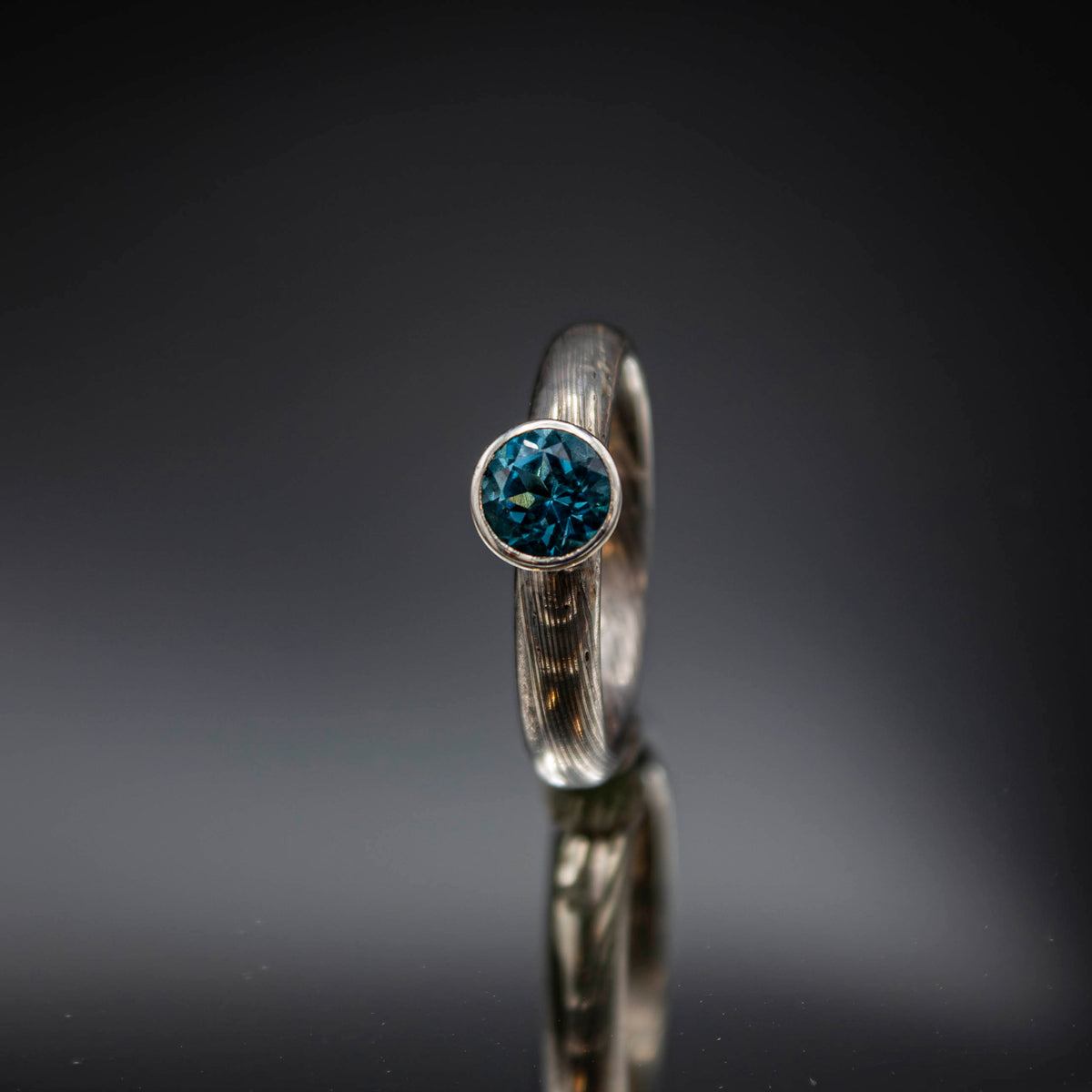 shibuichi mokume ring with blue topaz