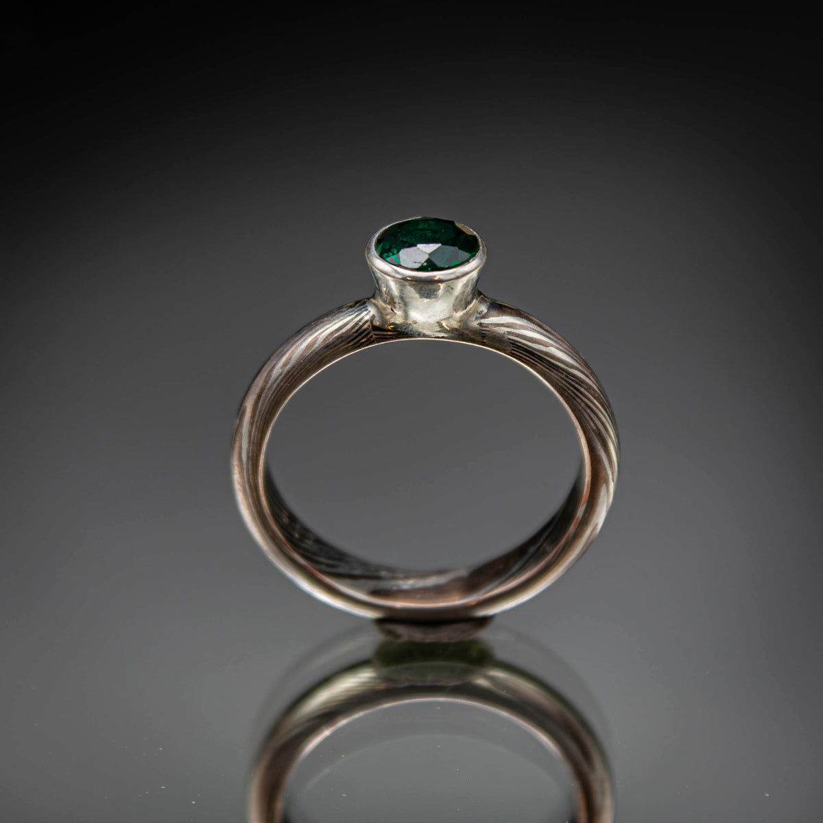 shibuichi mokume ring with emerald.