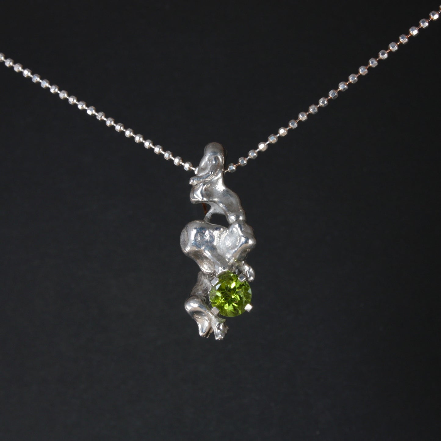 water cast silver necklace with peridot